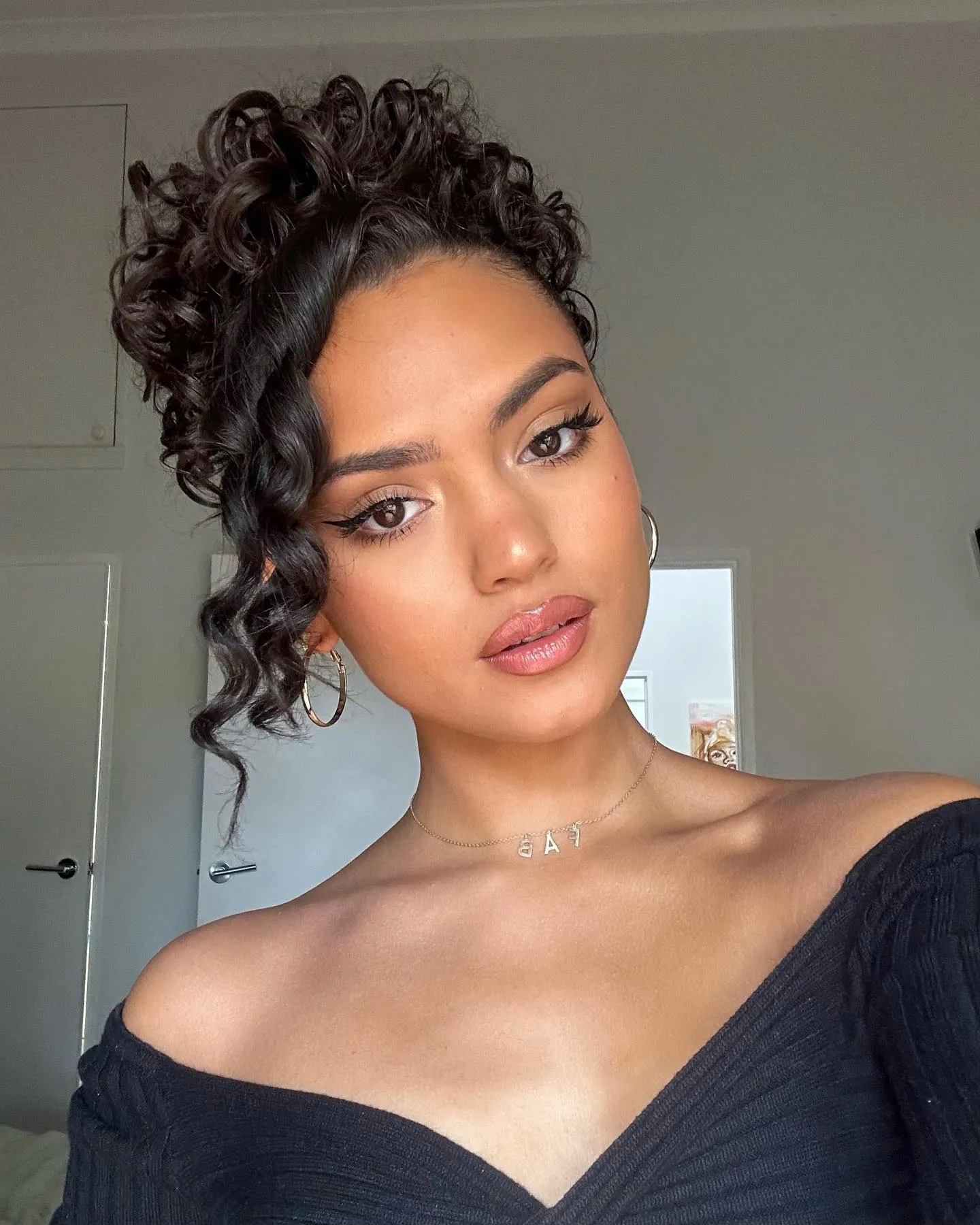 High Curly Bun With Tendrils