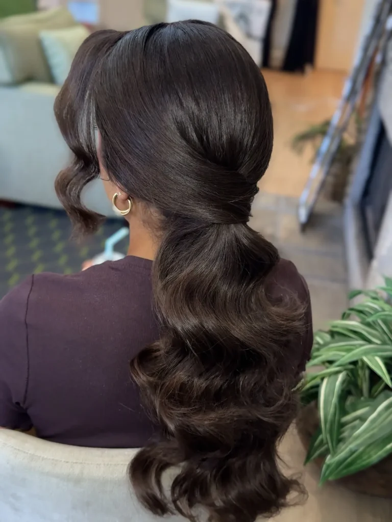 Sleek low ponytail voluminous ends
